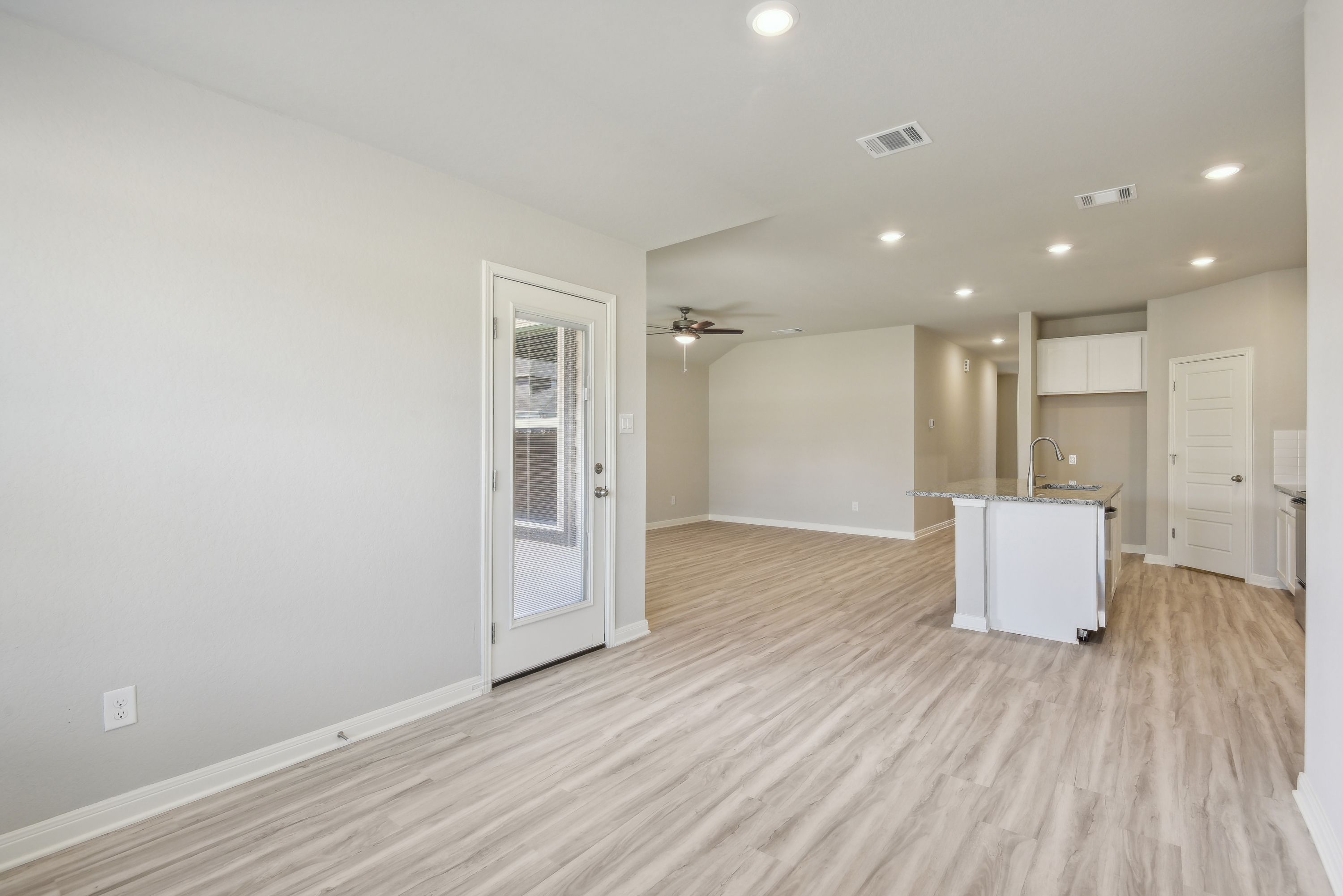 Dining room and kitchen in the Callaghan floorplan at a Meritage Homes community.