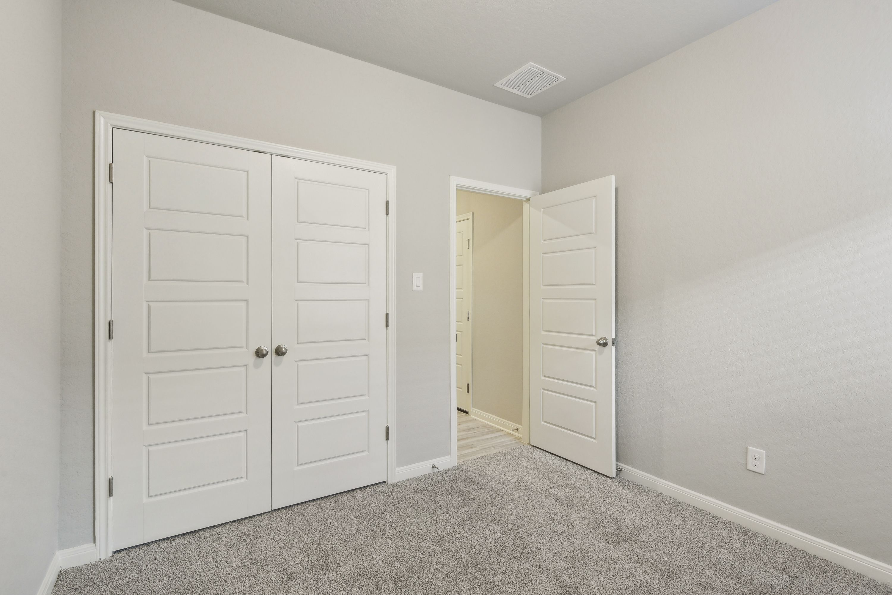 Guest bedroom in the Callaghan floorplan at a Meritage Homes community.