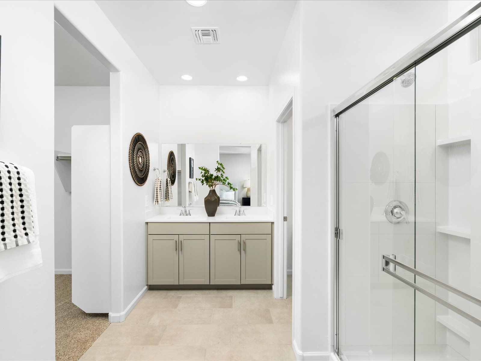 The primary bathroom features dual sinks and a walk-in closet with plenty of storage.