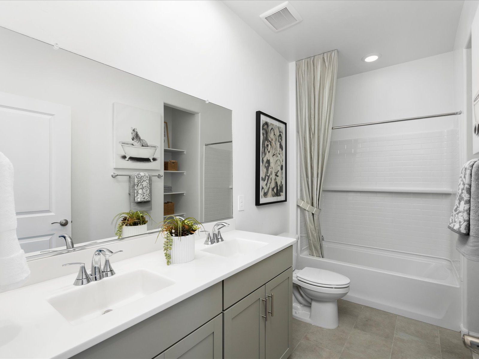 Enjoy dual sinks and built in storage in the second bathroom.