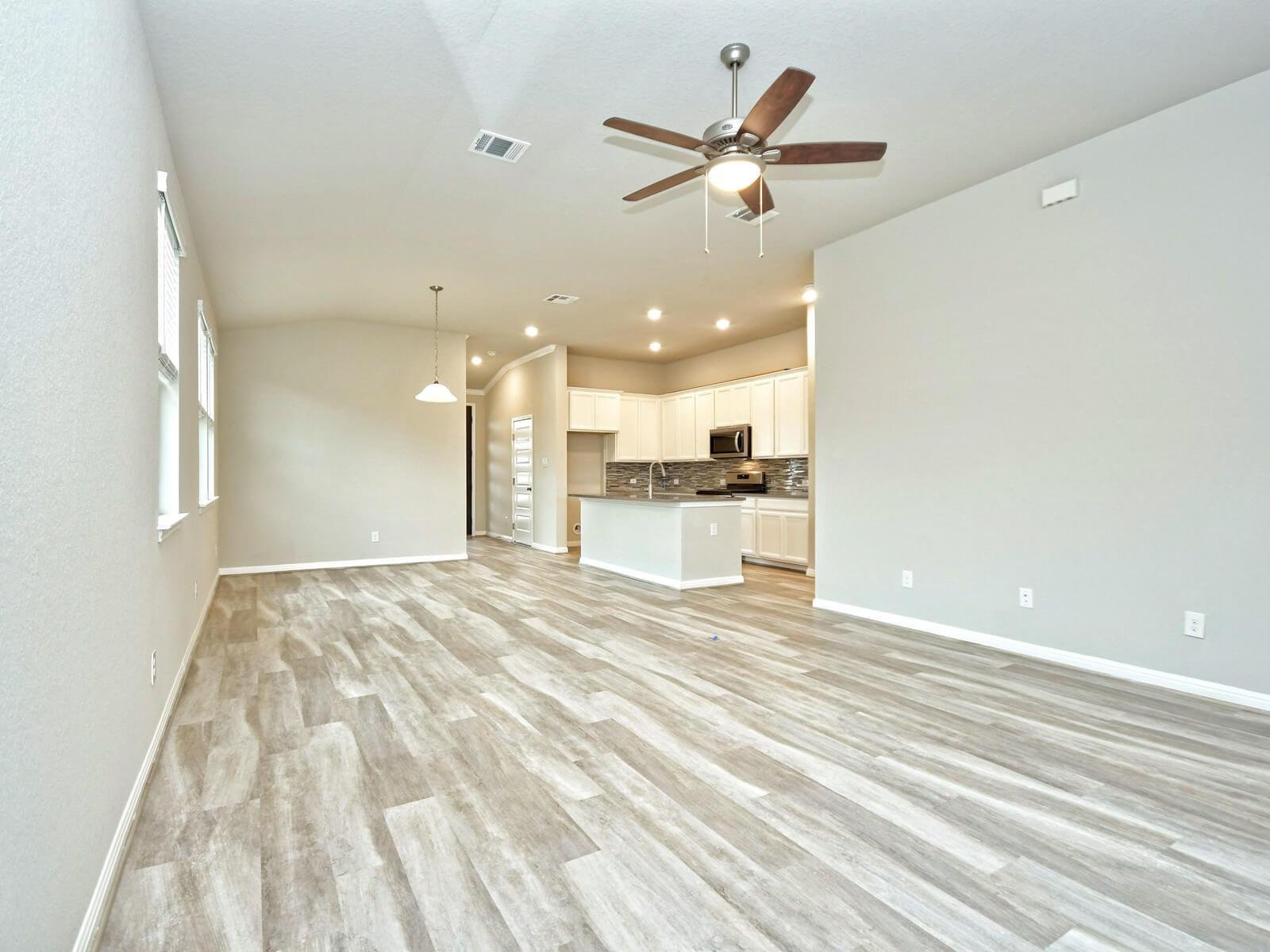 Dining and living room in the San Saba floorplan at a Meritage Homes community.