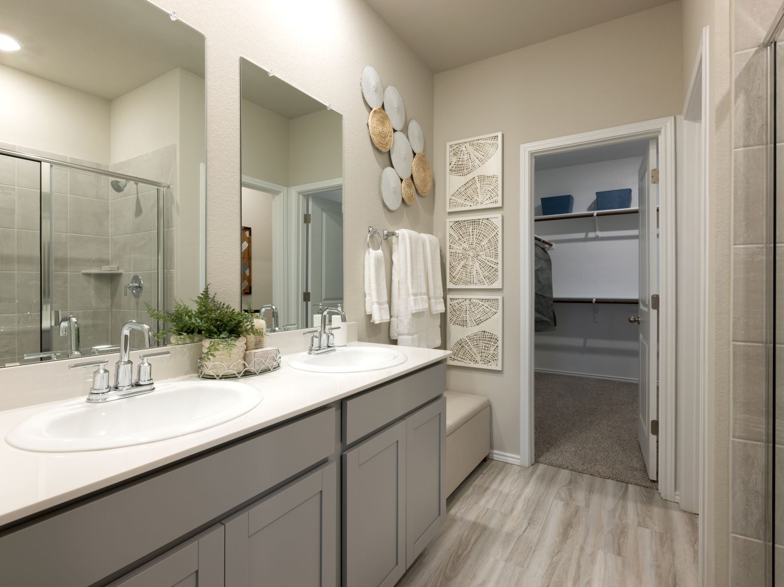The primary bathroom includes dual-sinks and a walk-in shower.