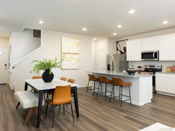 The dining room and kitchen island provide plenty of space to host guests.