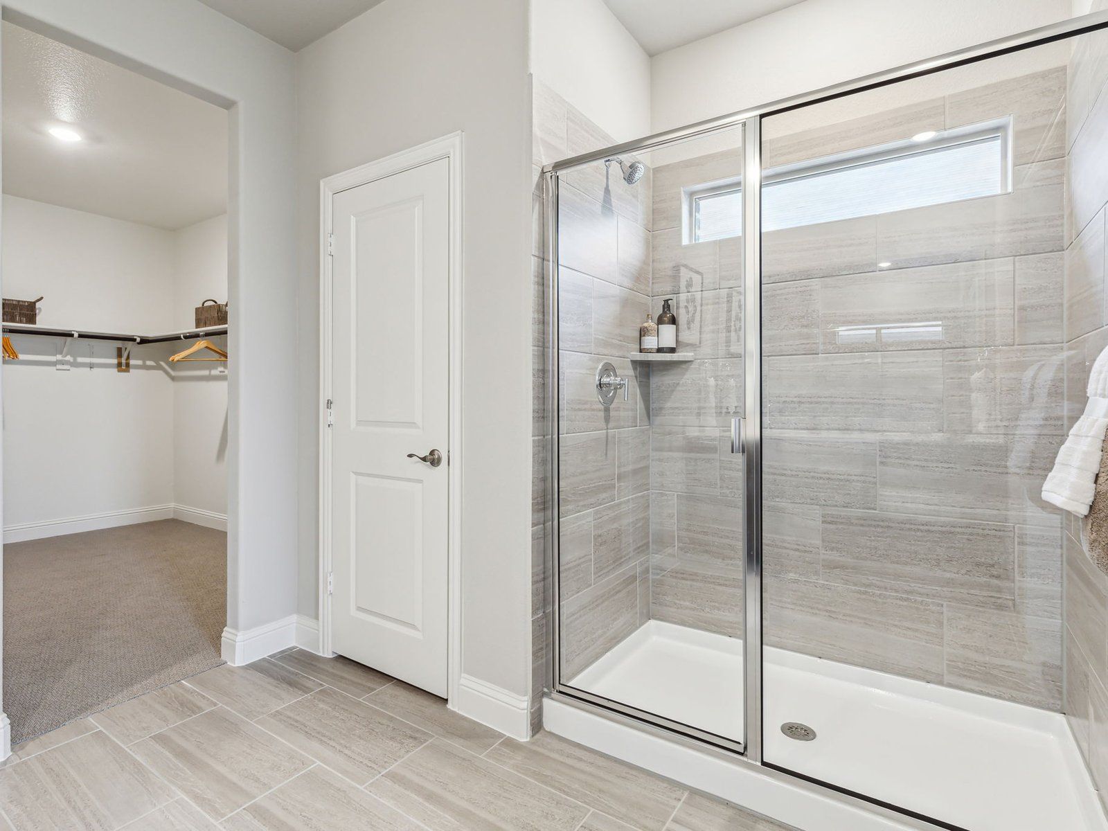 Primary bathroom with double vanity and large walk-in closet
