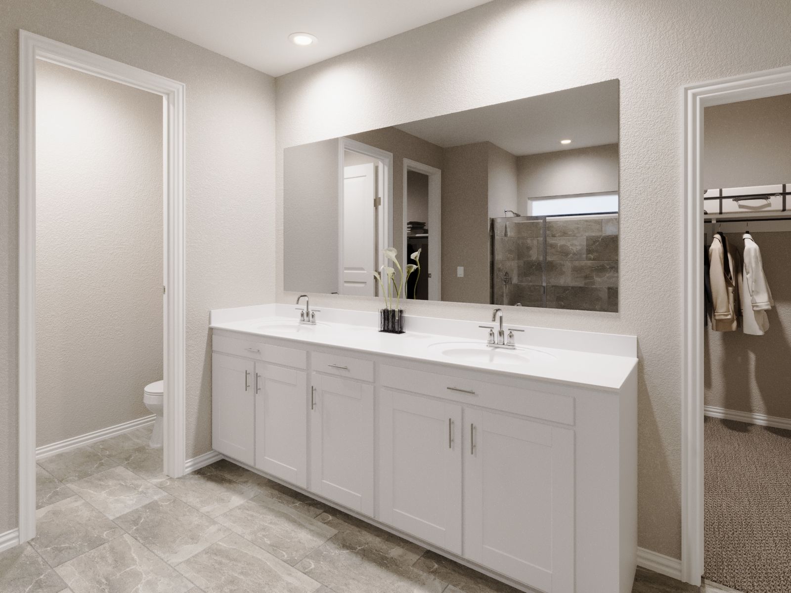 Primary bathroom with double vanity and large walk-in closet