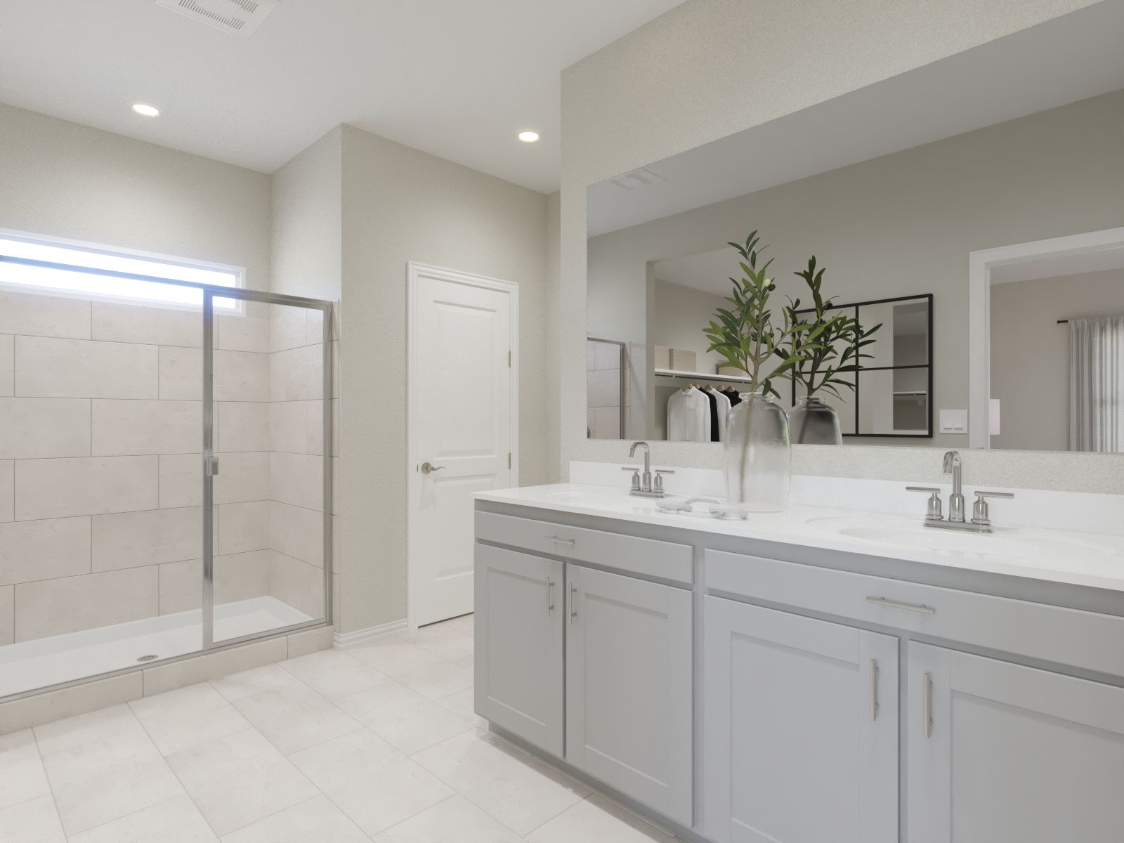 Primary bathroom with double vanity and large walk-in closet