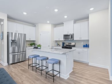 The spacious kitchen offers designer finishes and walk-in pantry.