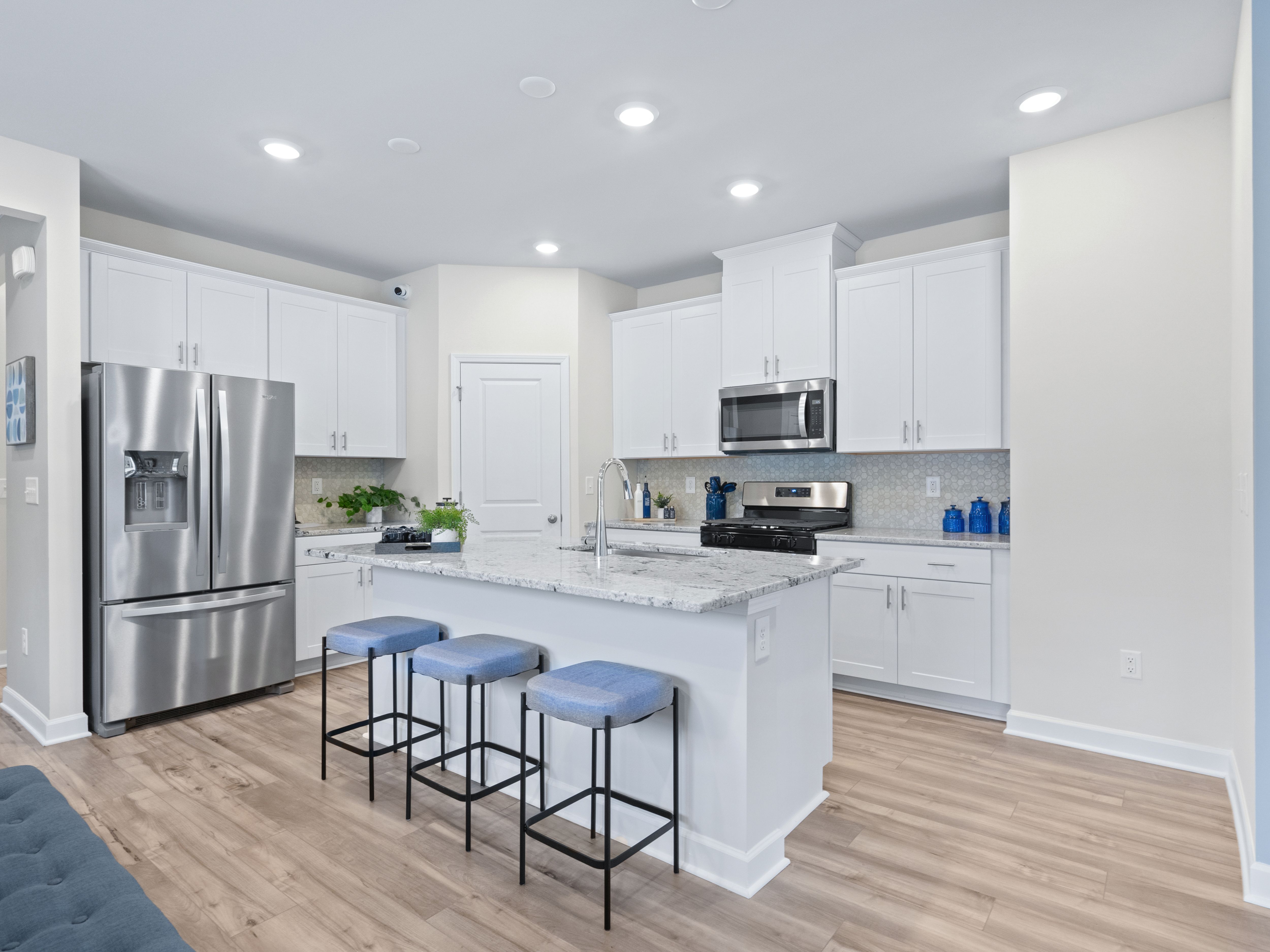 The spacious kitchen offers designer finishes and walk-in pantry.