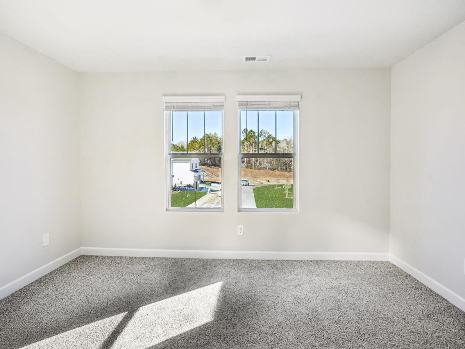 A secondary bedroom with plenty of natural light.