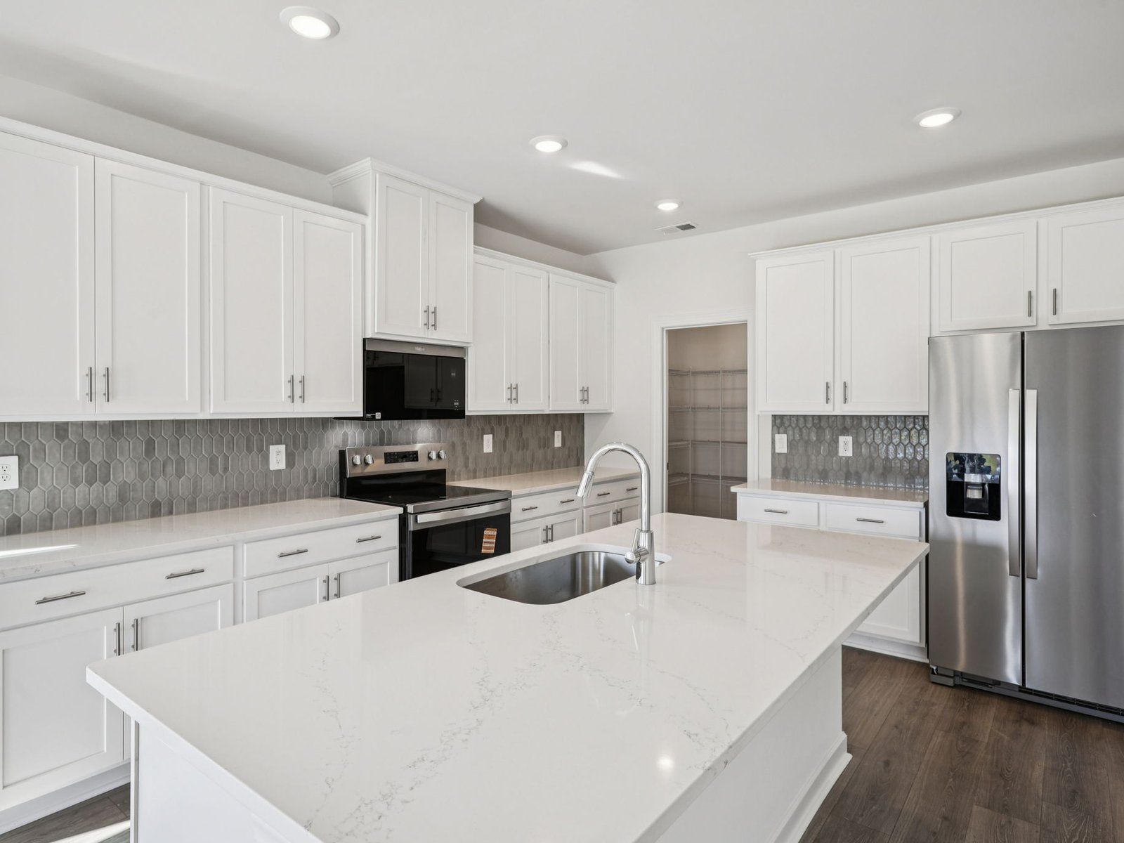 The oversized kitchen island is the perfect bar counter for additional seating.