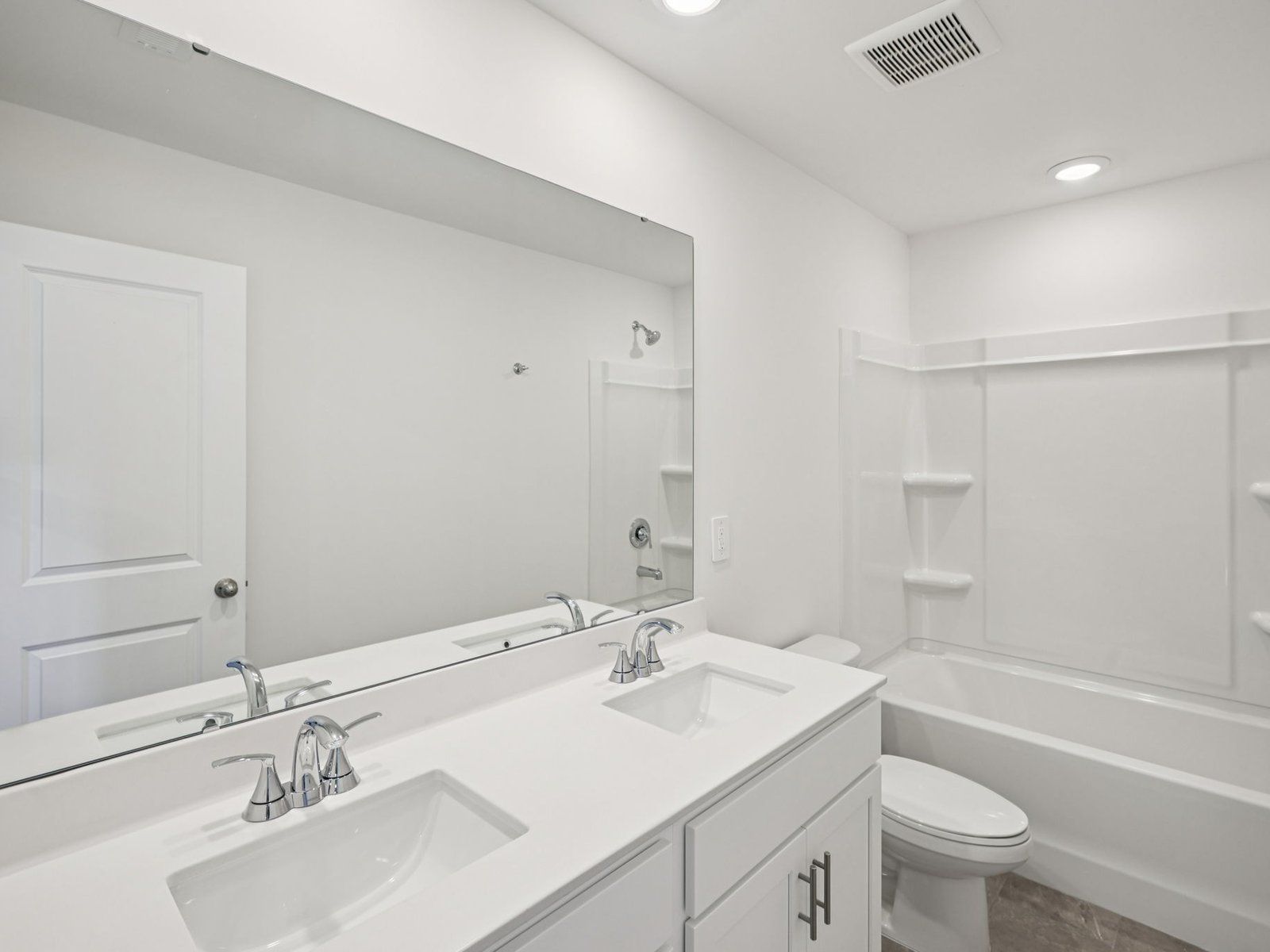 The secondary bathroom features a dual-sink vanity and oversized shower tub.