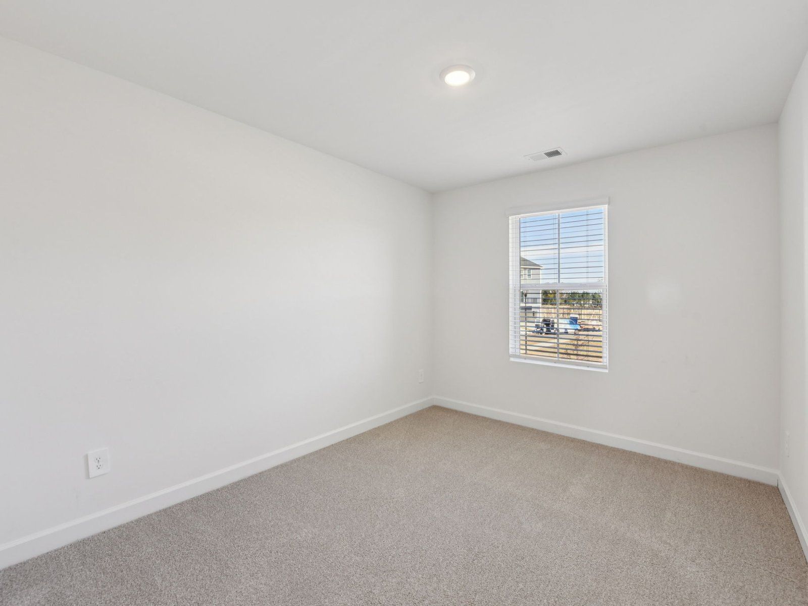 This secondary bedroom is the perfect space for a guest suite.