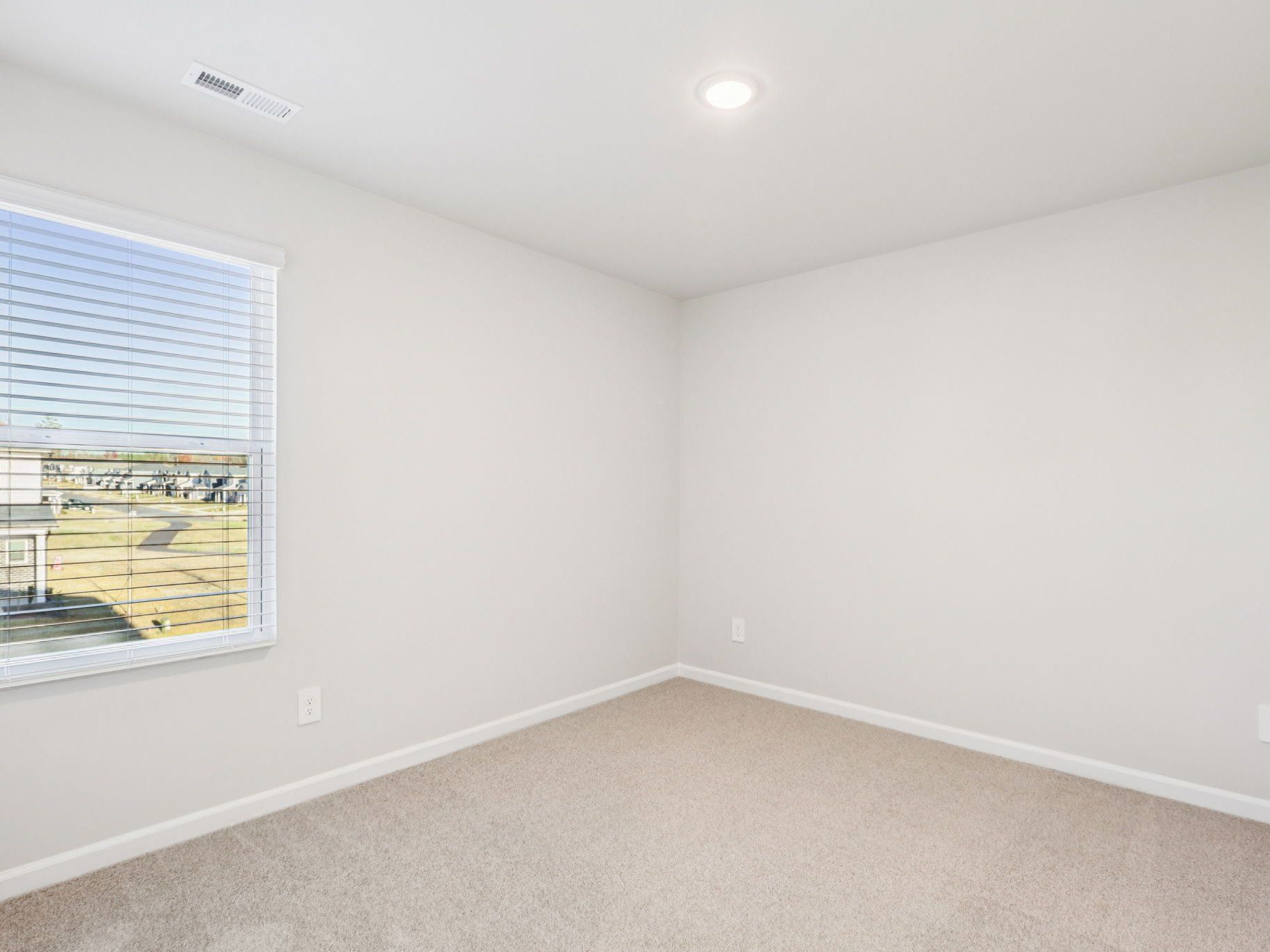 Secondary bedroom in the Lennon floorplan at a Meritage Homes community in Garner, NC.