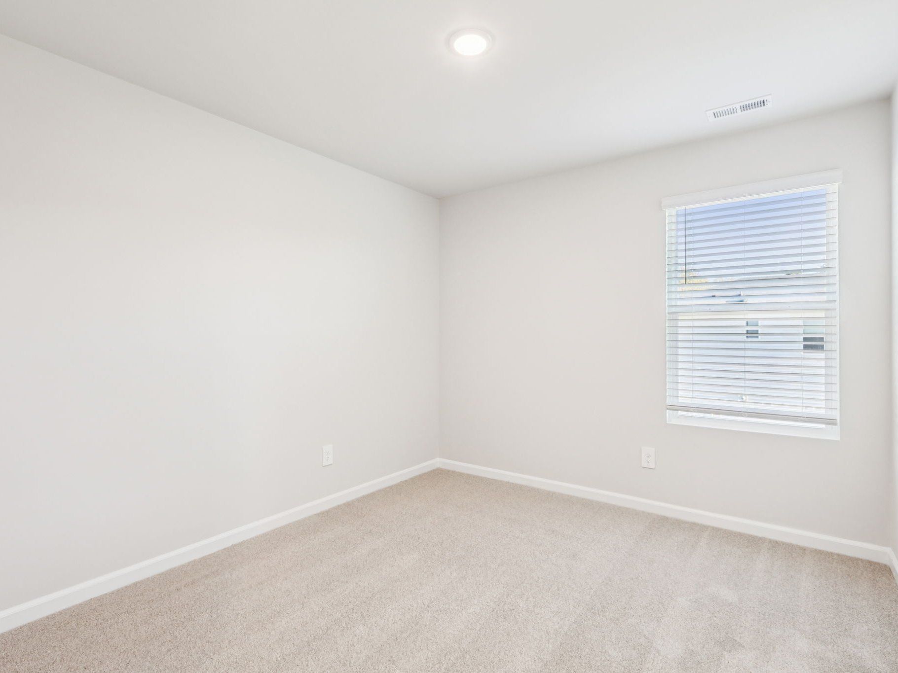 Secondary bedroom in the Lennon floorplan at a Meritage Homes community in Garner, NC.