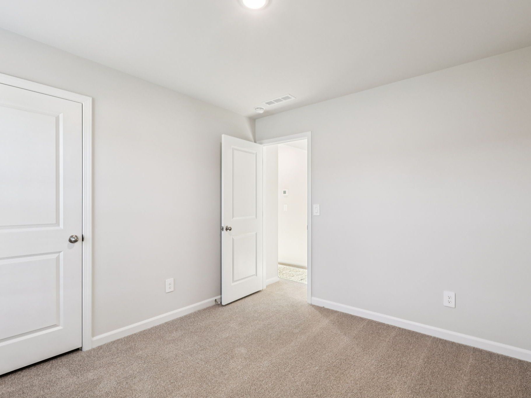 Secondary bedroom in the Lennon floorplan at a Meritage Homes community in Garner, NC.