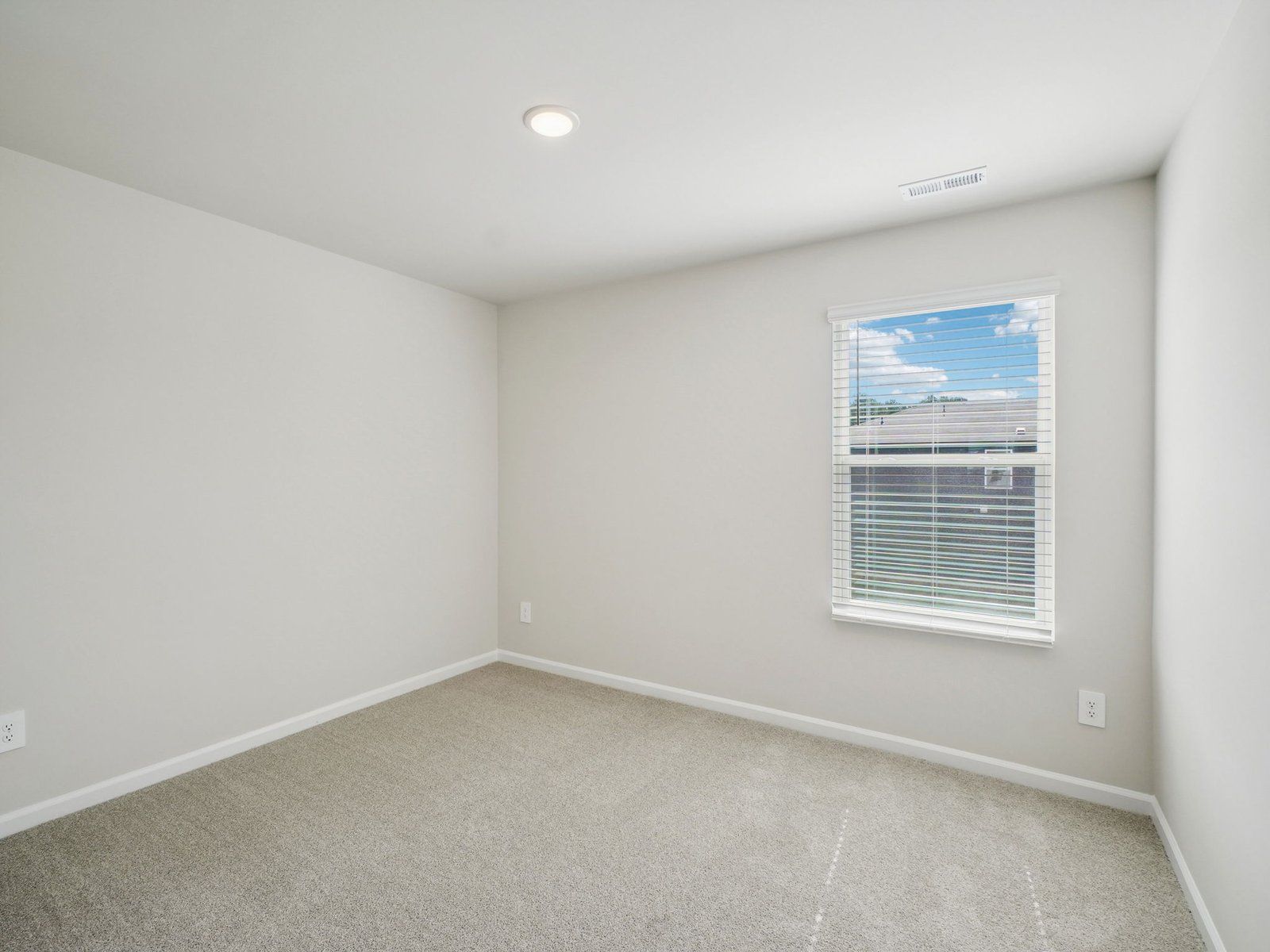 Secondary bedroom in the Paisley floorplan at a Meritage Homes community in Garner, NC.