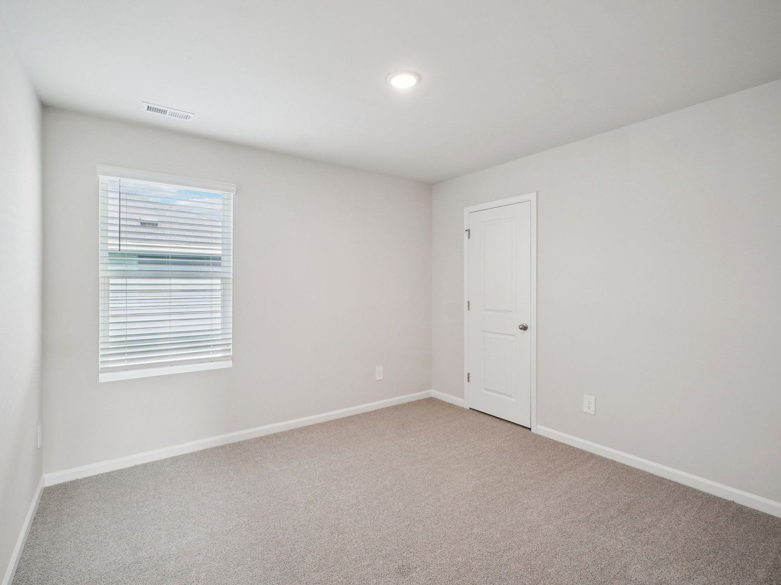 Secondary bedroom in the Paisley floorplan at a Meritage Homes community in Garner, NC.