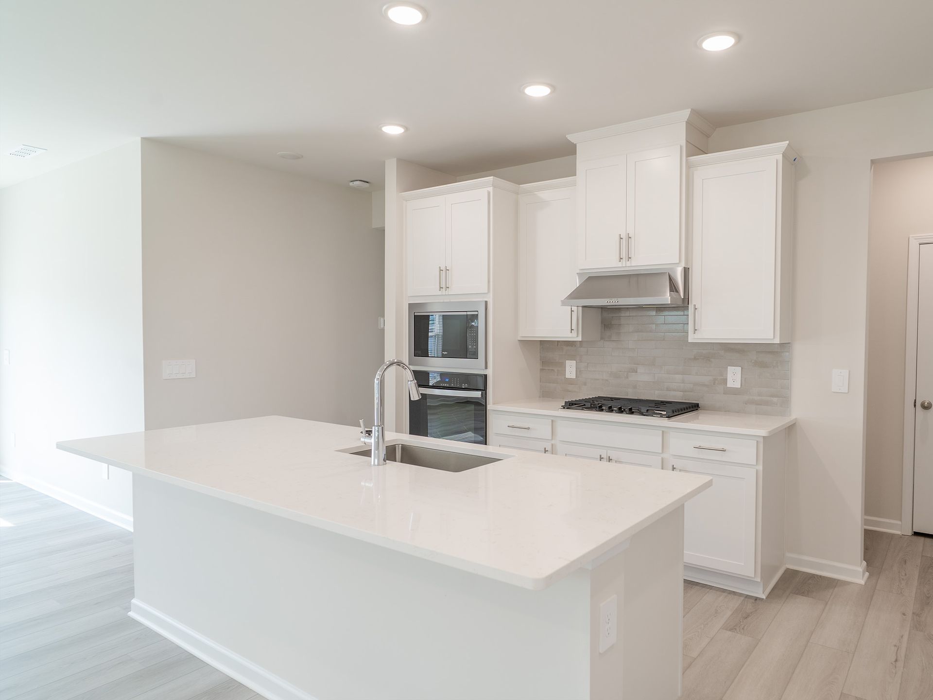 Kitchen in the Roswell floorplan at a Meritage Homes community in Garner, NC.