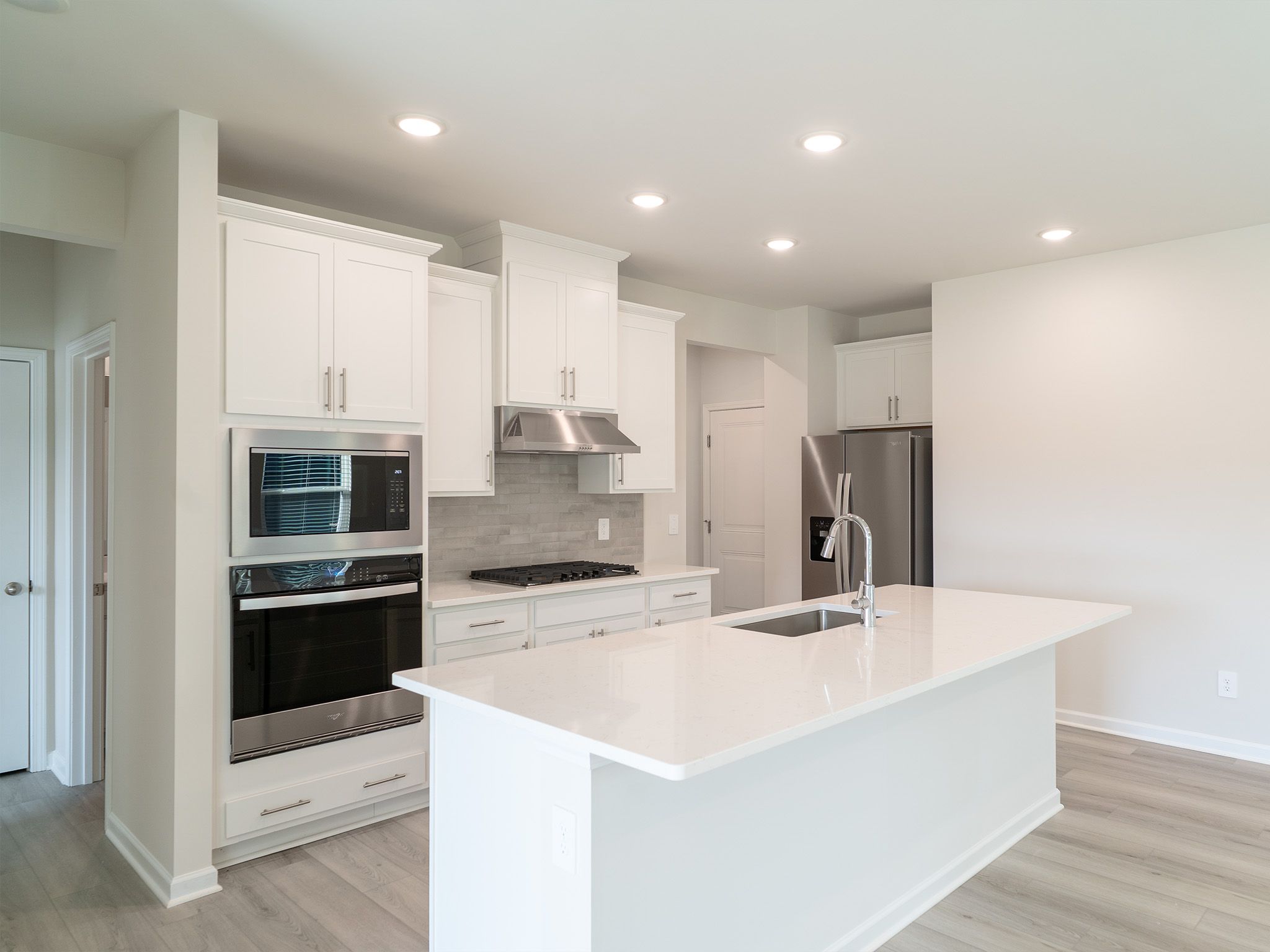Kitchen in the Roswell floorplan at a Meritage Homes community in Garner, NC.