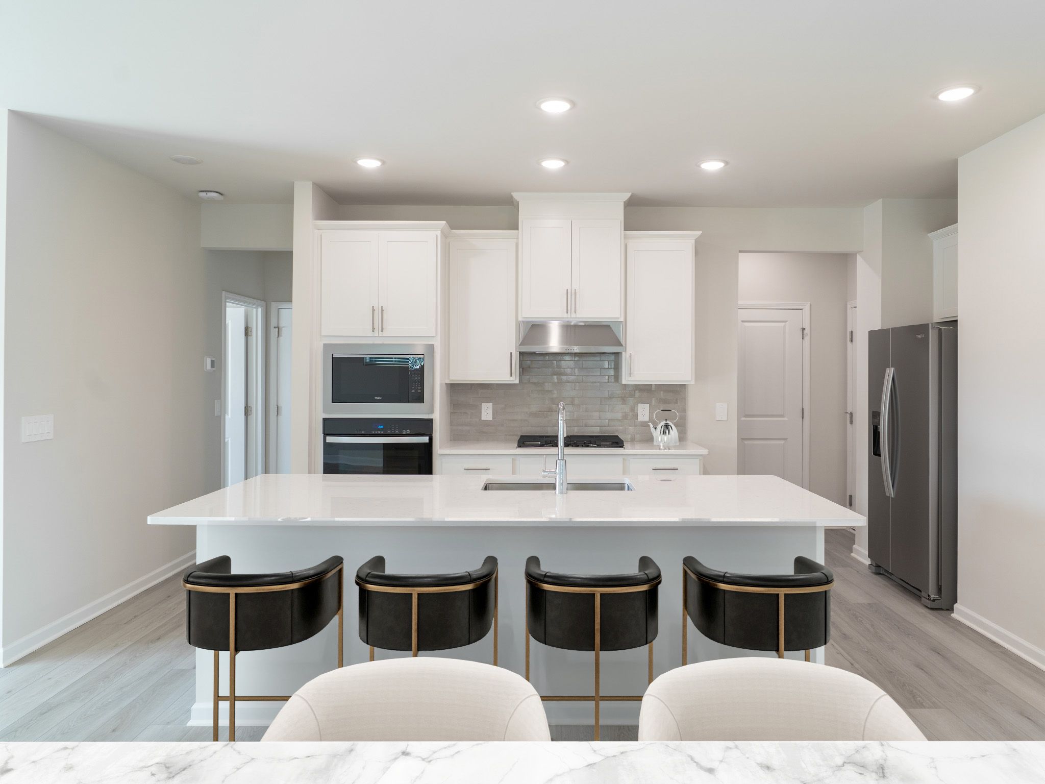 Kitchen in the Roswell floorplan at a Meritage Homes community in Garner, NC.