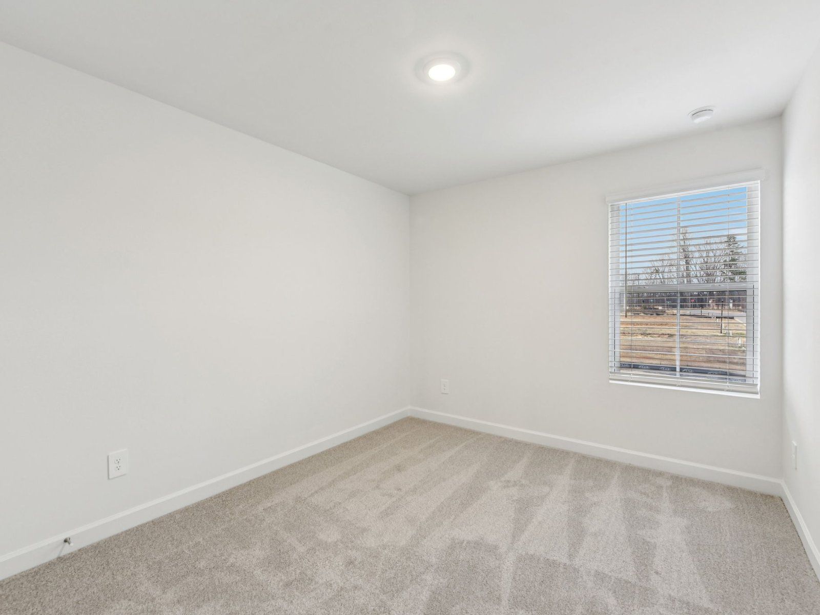 This secondary bedroom makes for the perfect home office or gym.