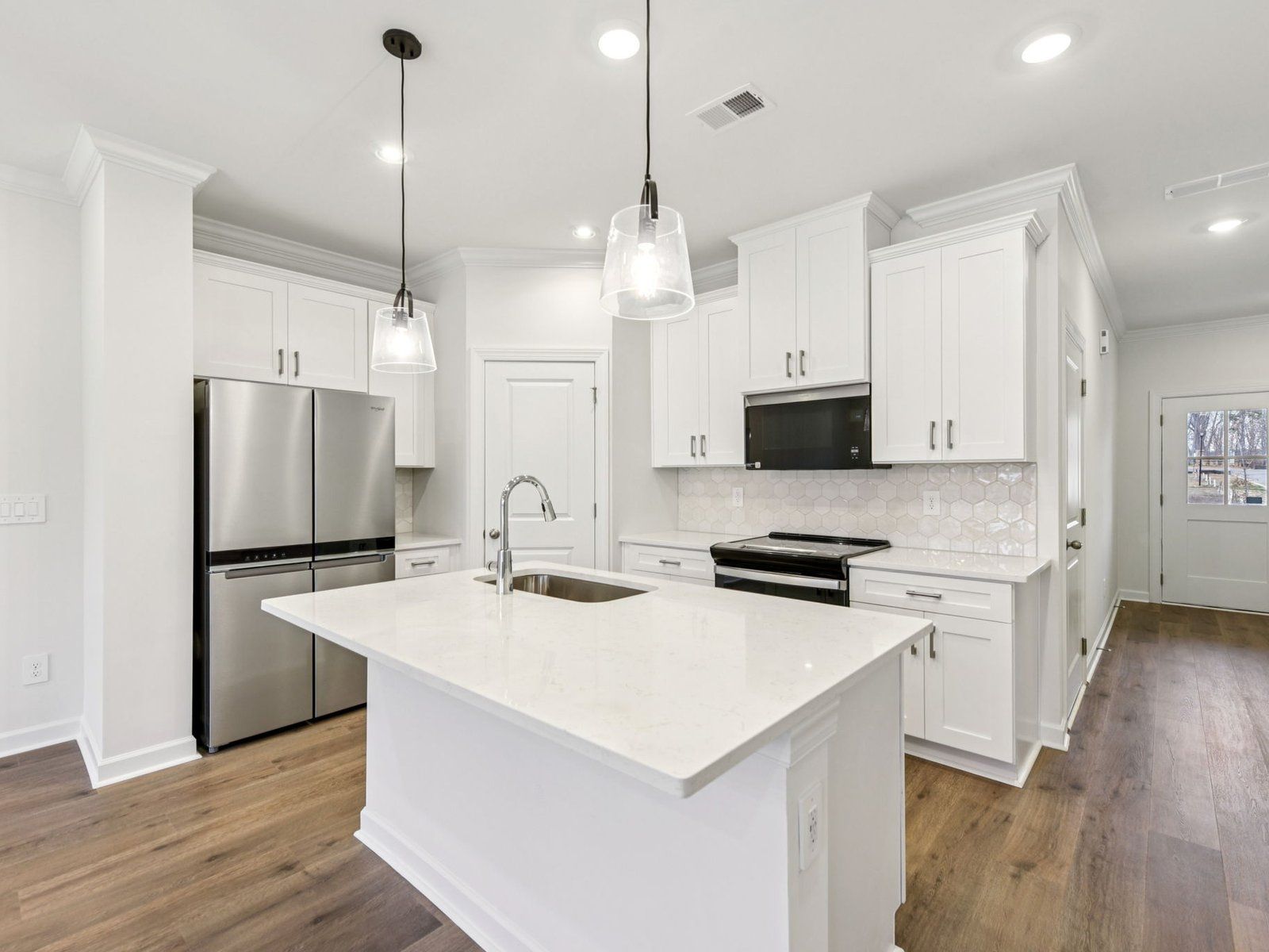 The oversized kitchen island is the perfect bar counter for additional seating.