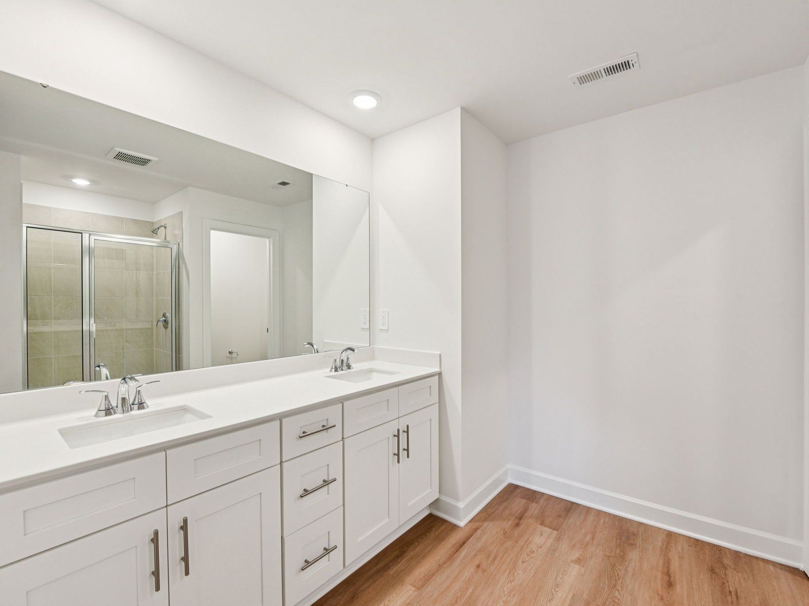 The primary bathroom boasts a dual-sink vanity with storage for your self-care essentials.