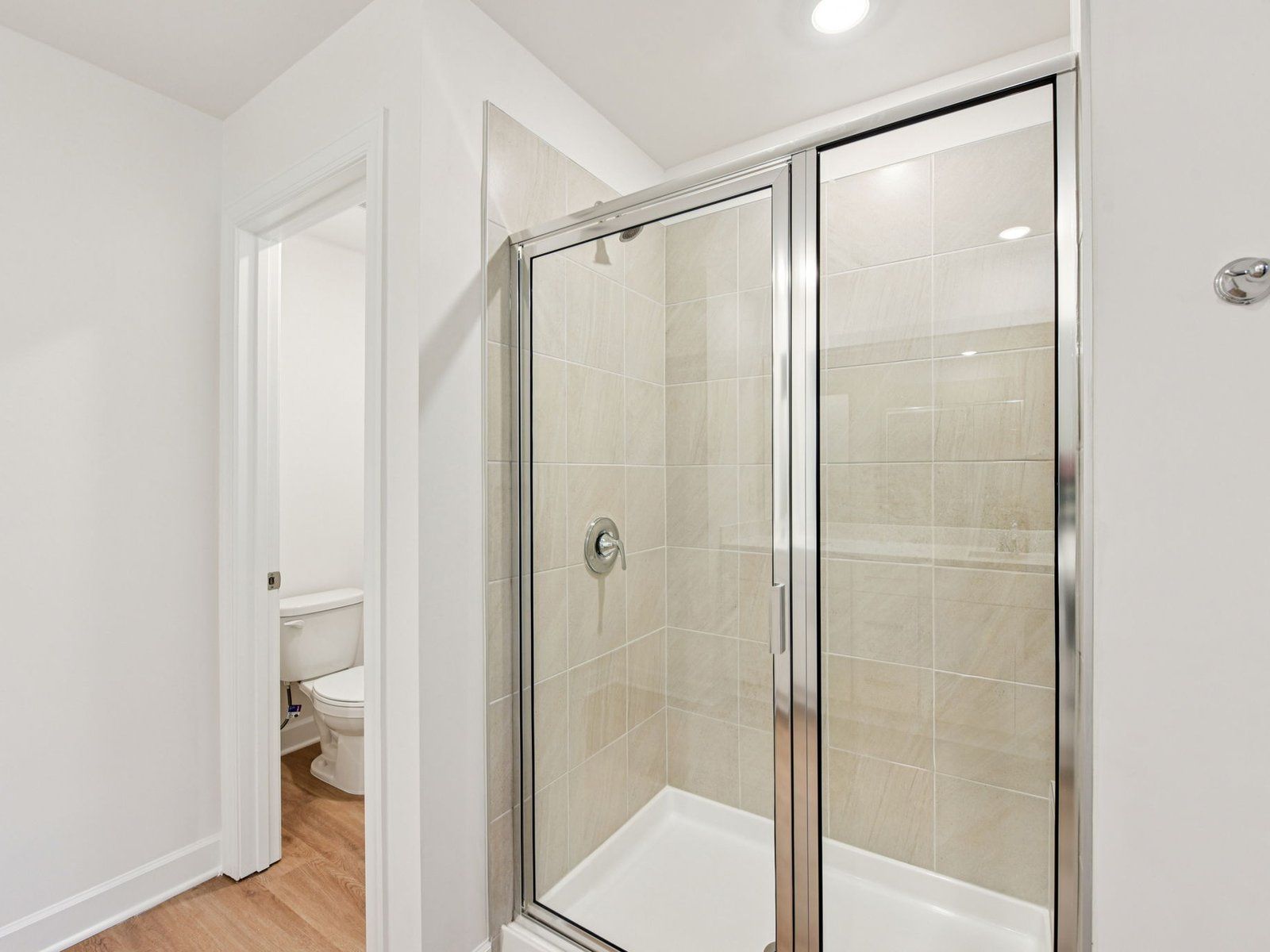 Enjoy a spa-like experience in the primary bathroom's modern walk-in shower.