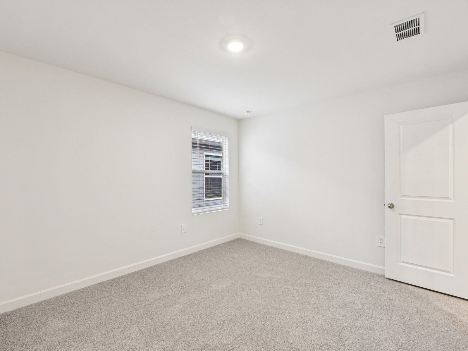 This secondary bedroom makes for a perfect home office or workout room.