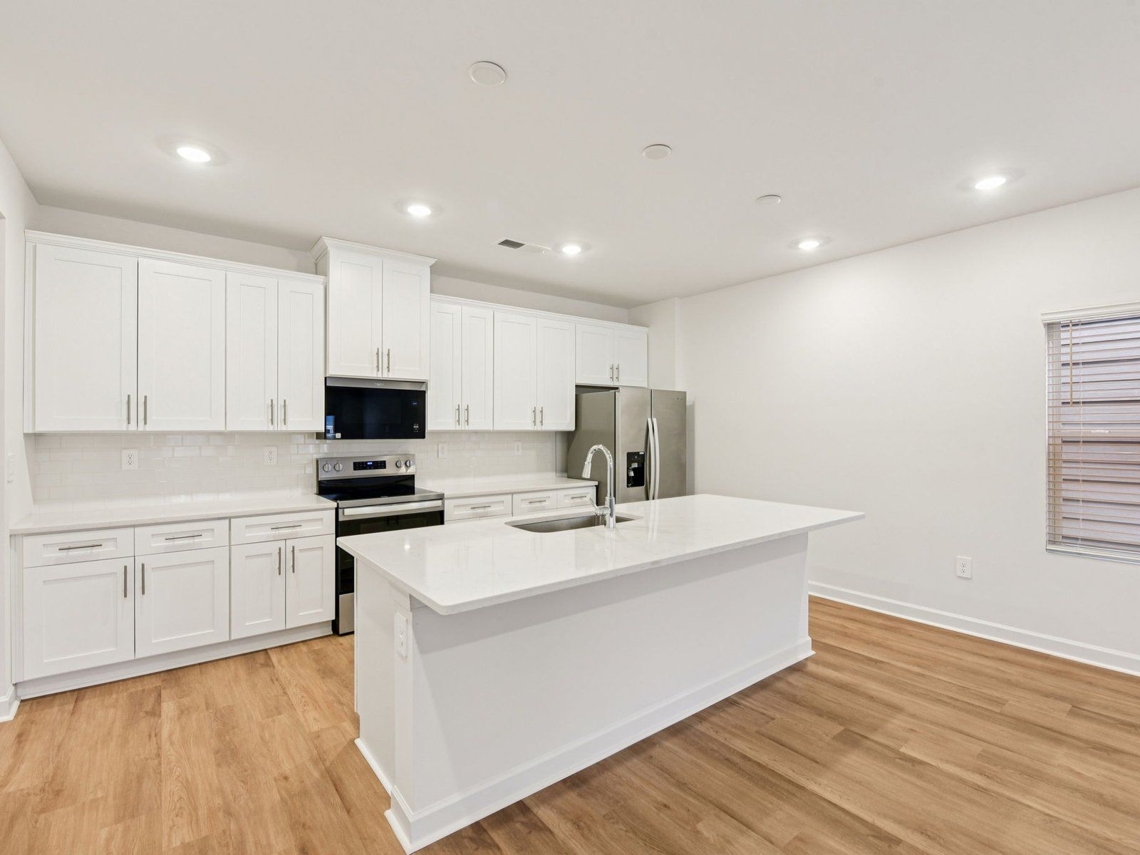 The oversized kitchen island makes for the perfect bar counter for additional seating.