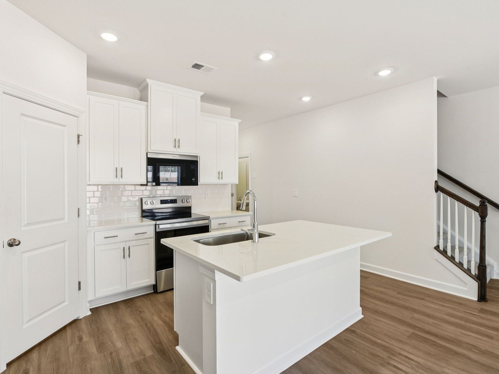 The oversized kitchen island makes for the perfect bar counter for additional seating.