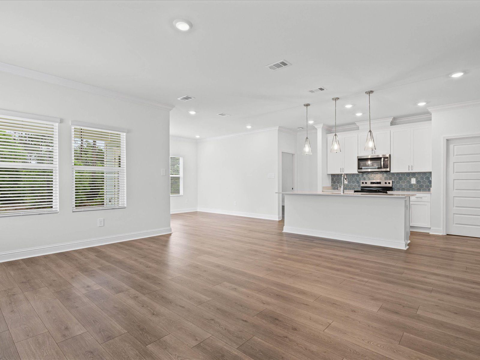 Great room in the Carolina floorplan at a Meritage Homes community in Ocean Springs, MS.