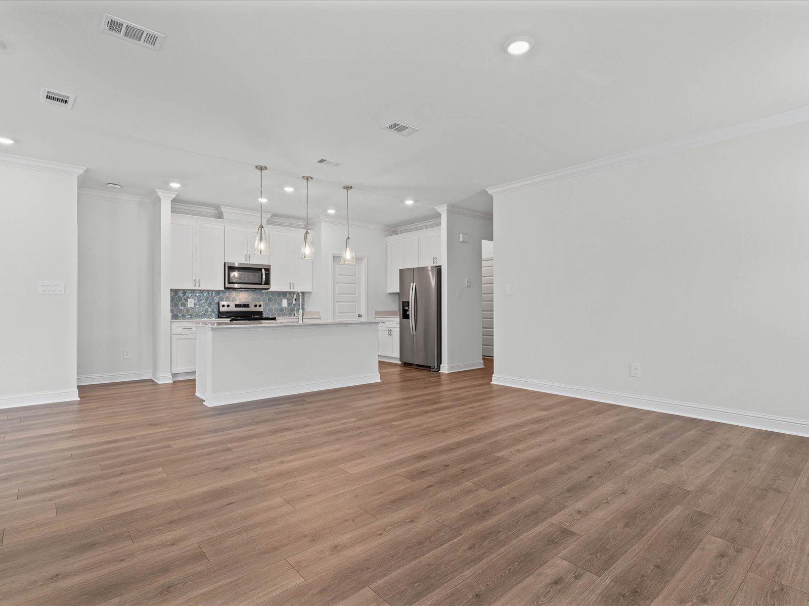 Great room in the Carolina floorplan at a Meritage Homes community in Ocean Springs, MS.