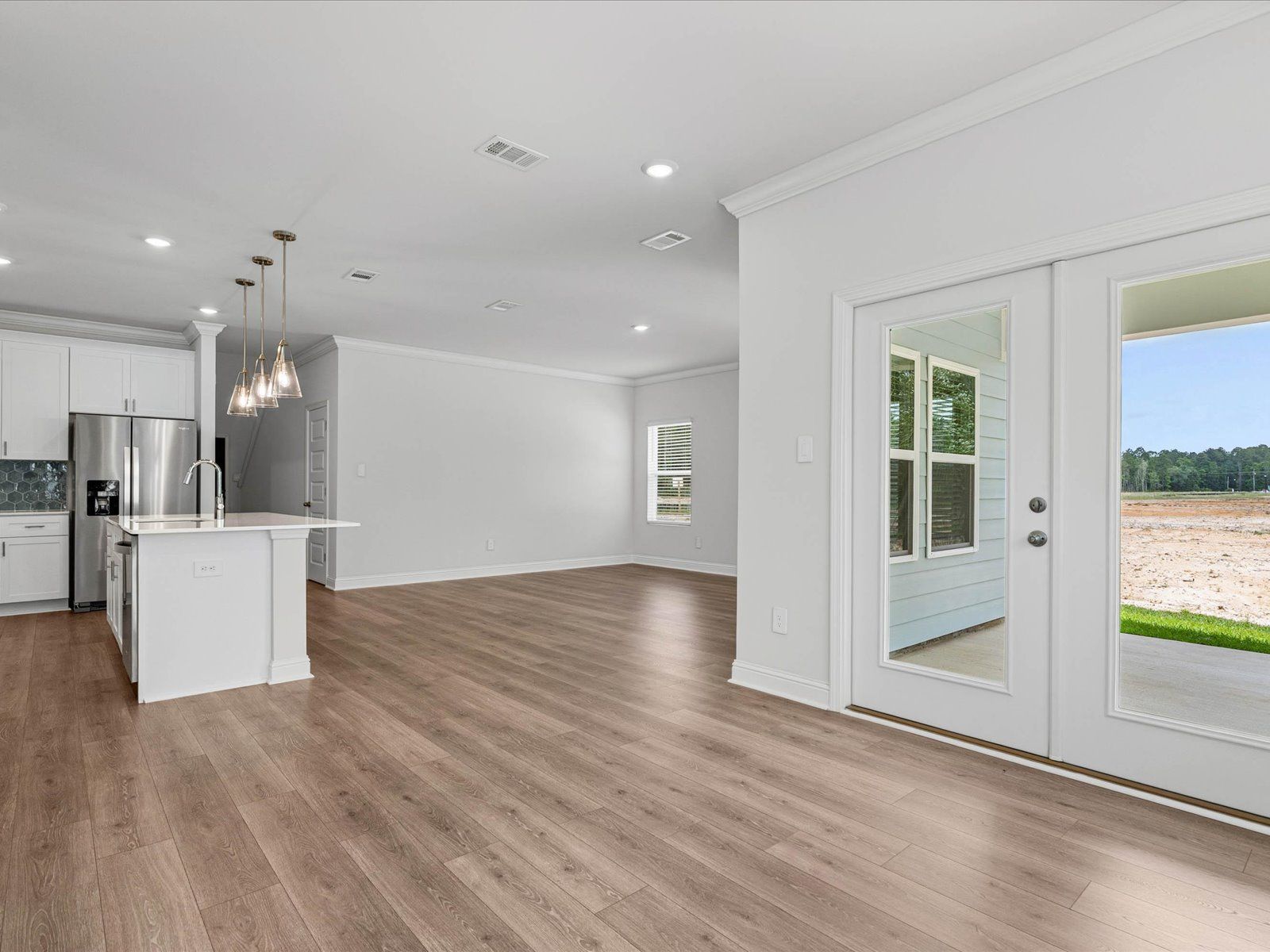 Great room in the Carolina floorplan at a Meritage Homes community in Ocean Springs, MS.