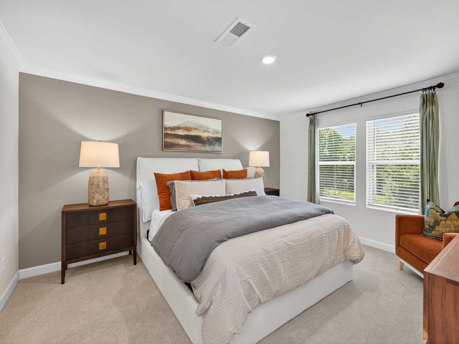 Relax and unwind after a long day in the spacious primary bedroom.