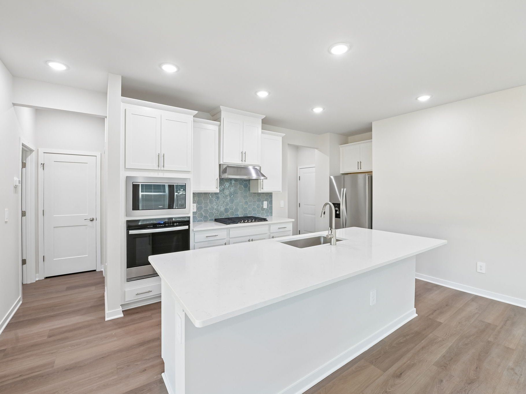 Kitchen in the Roswell floorplan at a Meritage Homes community in Wendell, NC.