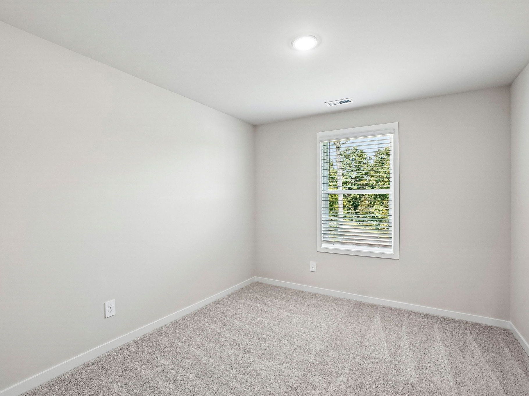 Secondary bedroom in the Wilson floorplan at a Meritage Homes community in Clayton, NC.