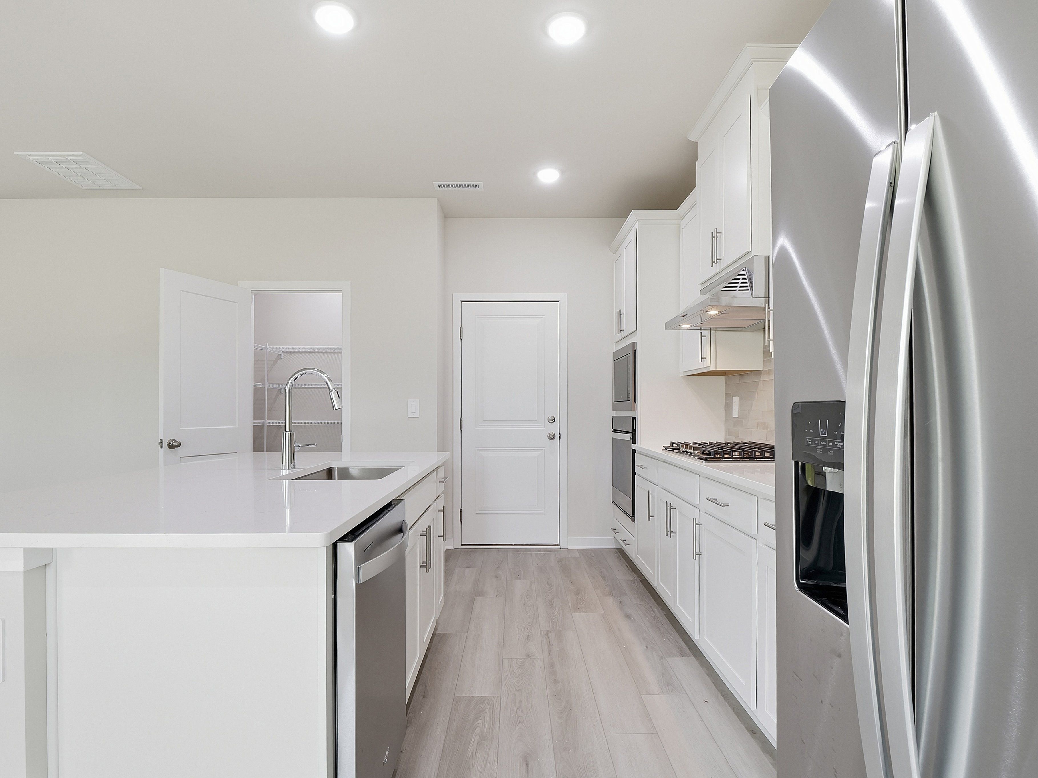 Kitchen in the Dallas floorplan at a Meritage Homes community in Wendell, NC.