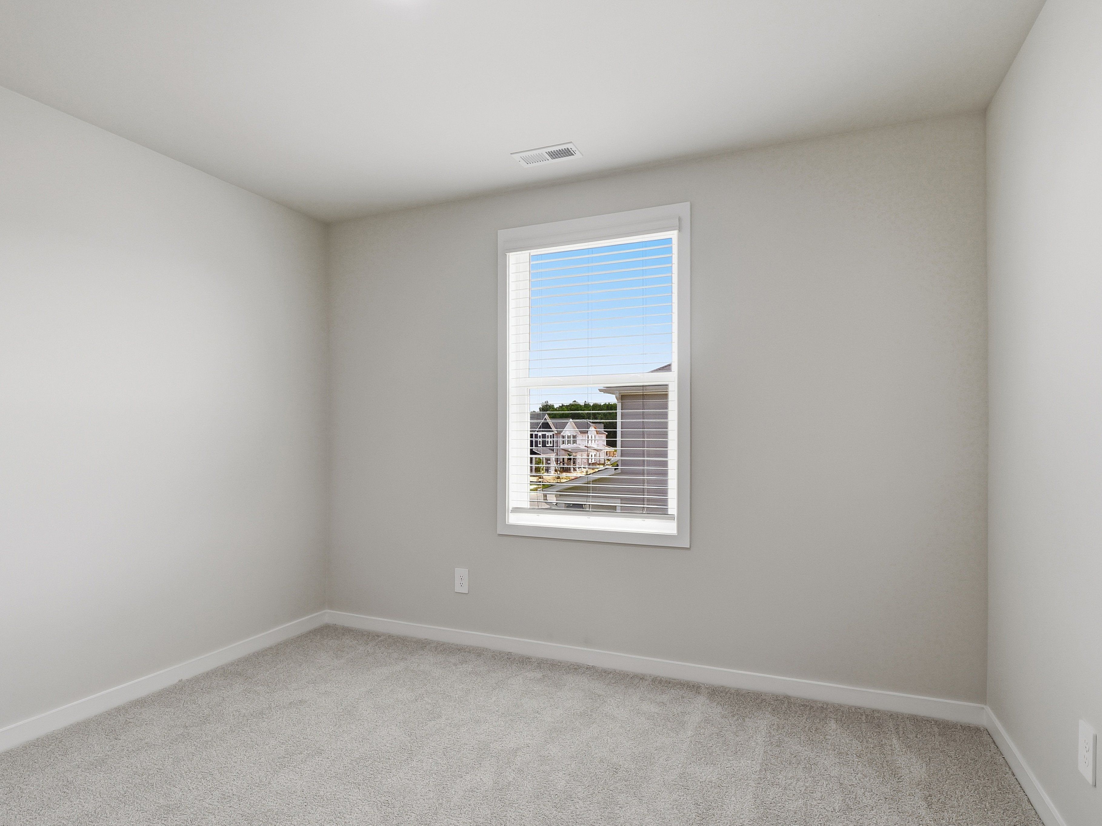 Secondary bedroom in the Dallas floorplan at a Meritage Homes community in Wendell, NC.