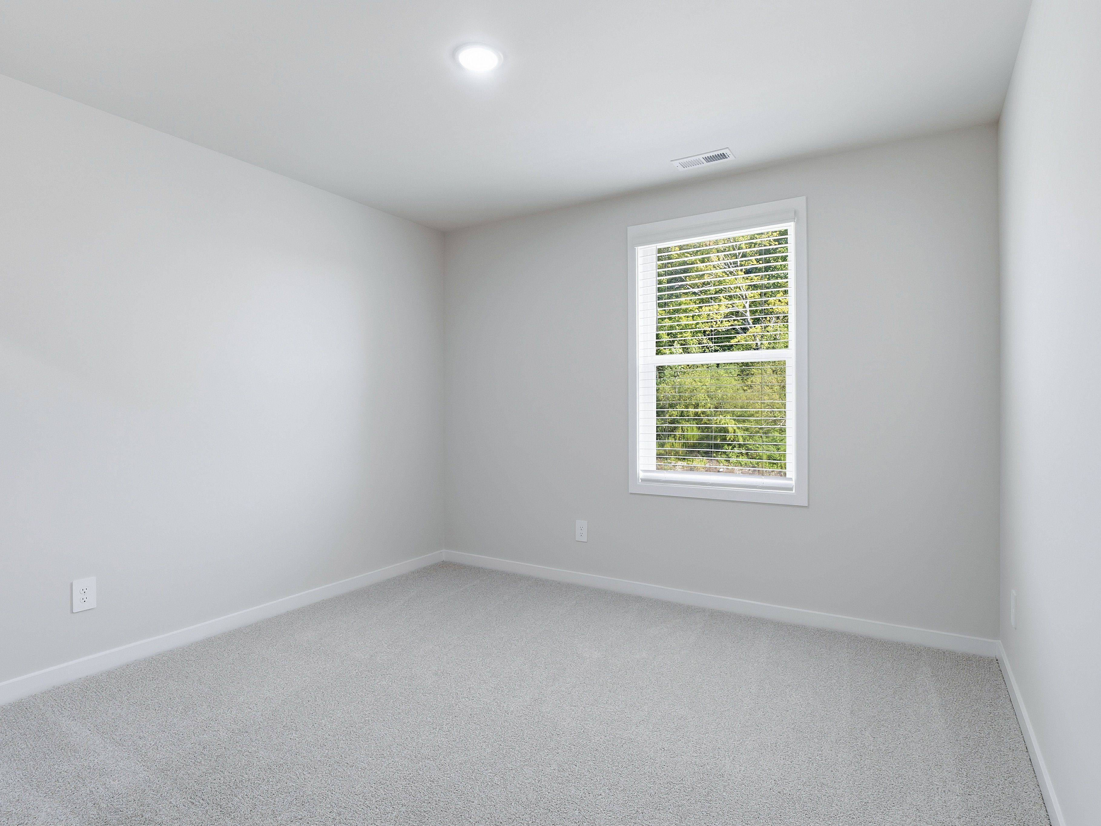 Secondary bedroom in the Johnson floorplan at a Meritage Homes community in Wendell, NC.