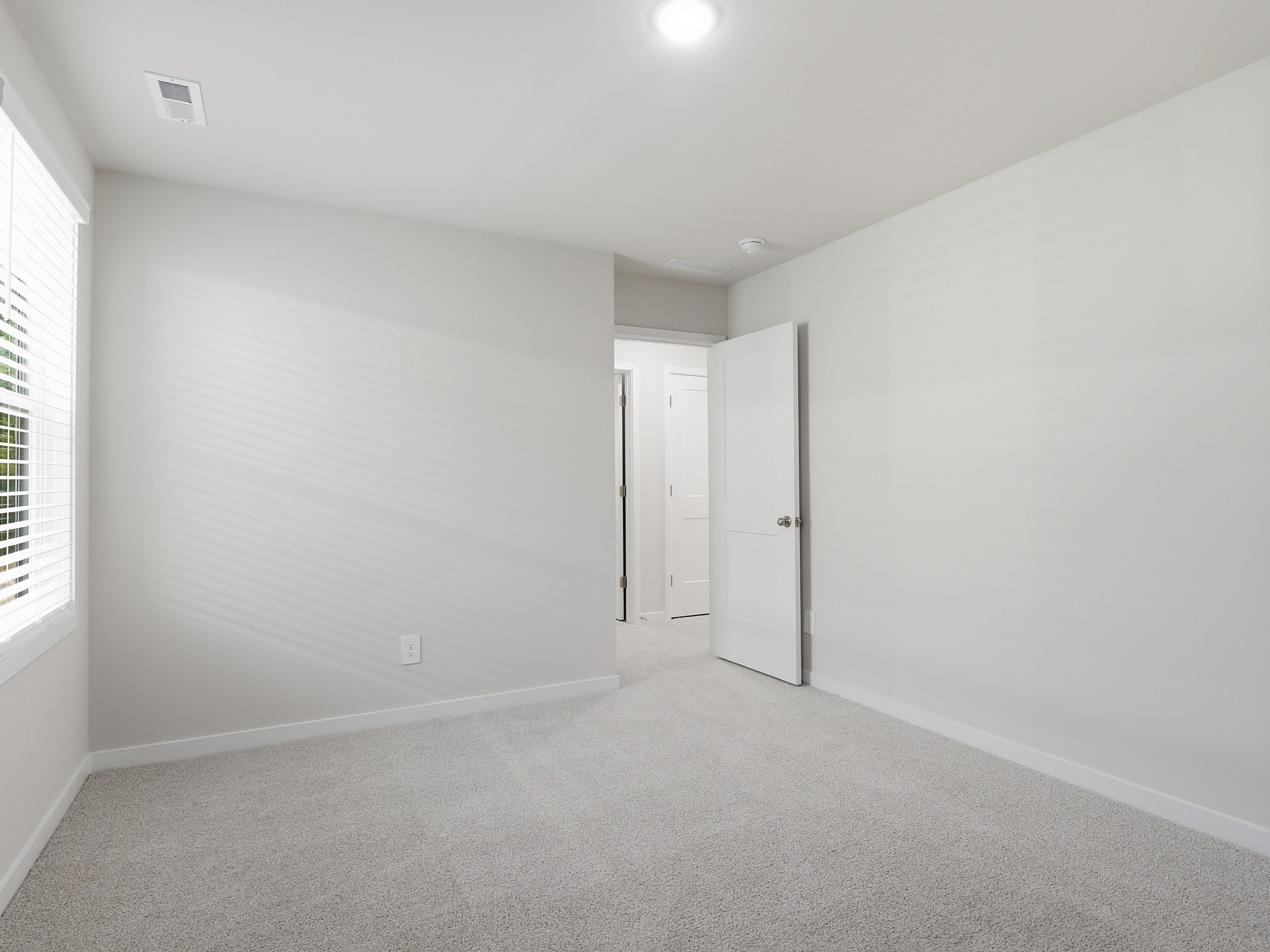 Secondary bedroom in the Johnson floorplan at a Meritage Homes community in Wendell, NC.