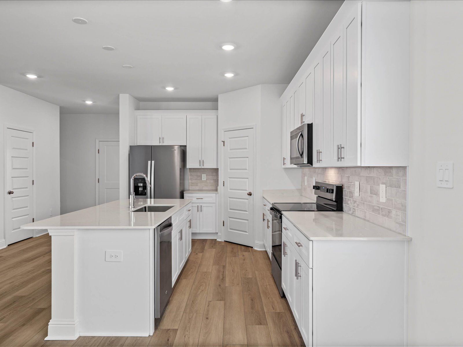 Kitchen in the Fraser floorplan at a Meritage Homes community in Ocean Springs, MS.