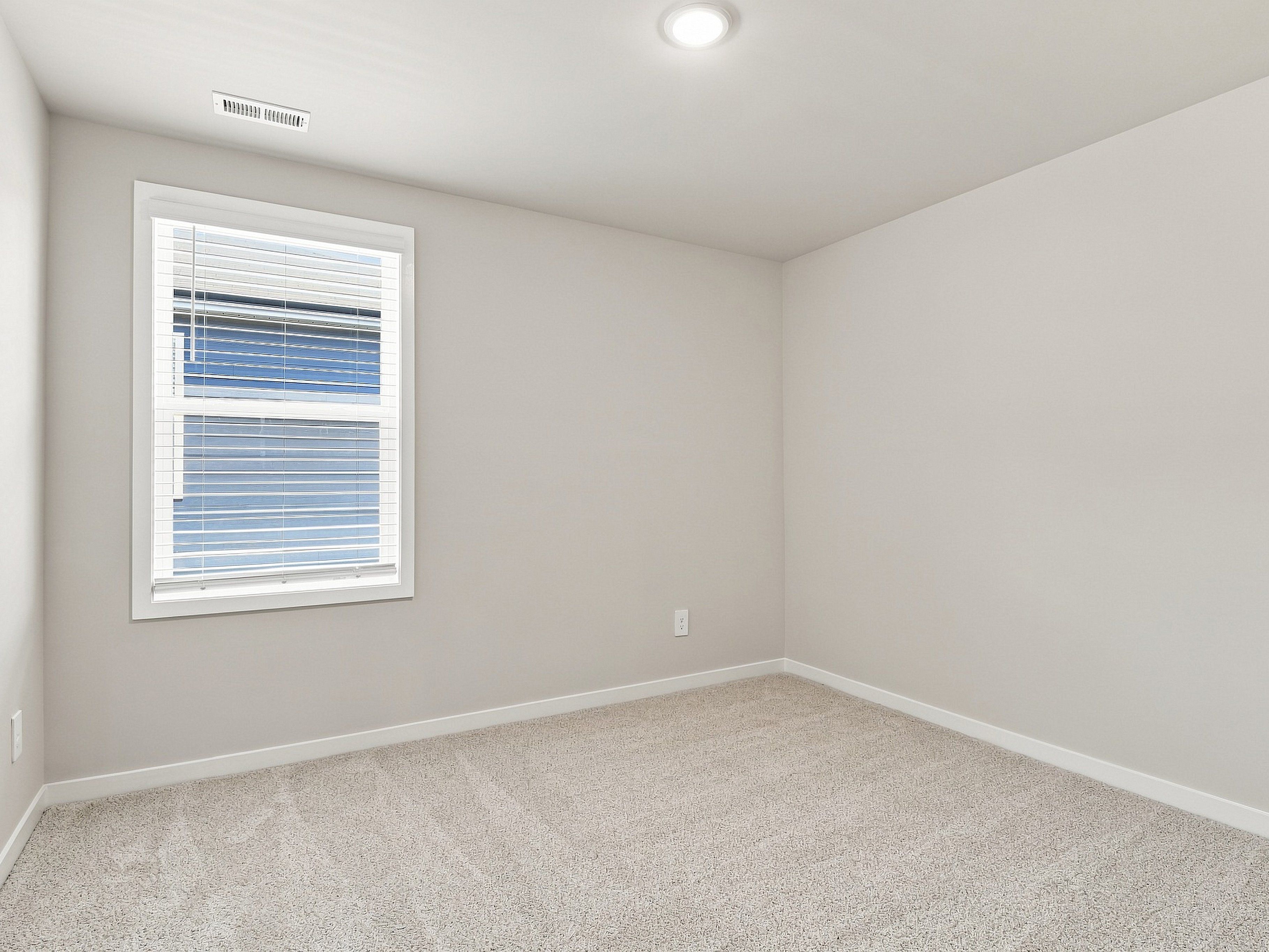 Secondary bedroom in the Paisley floorplan at a Meritage Homes community in Durham, NC.