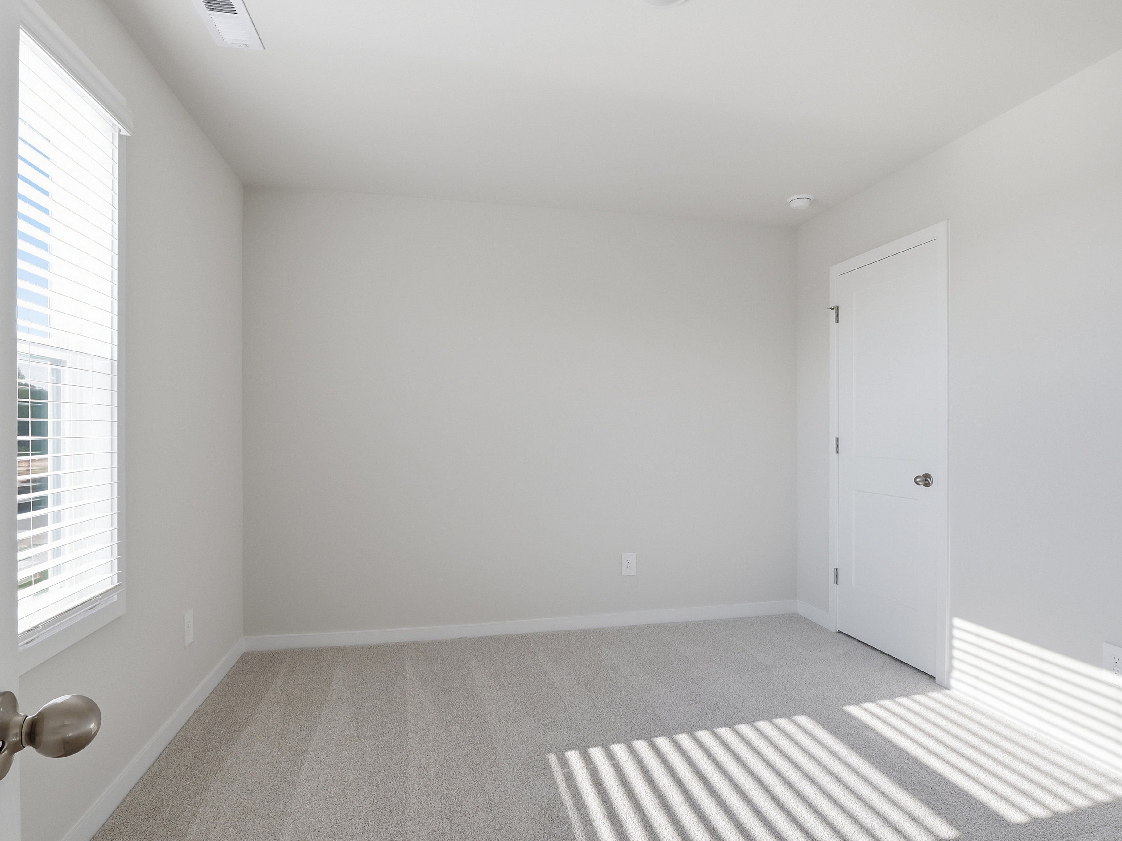 Secondary bedroom in the Paisley floorplan at a Meritage Homes community in Clayton, NC.