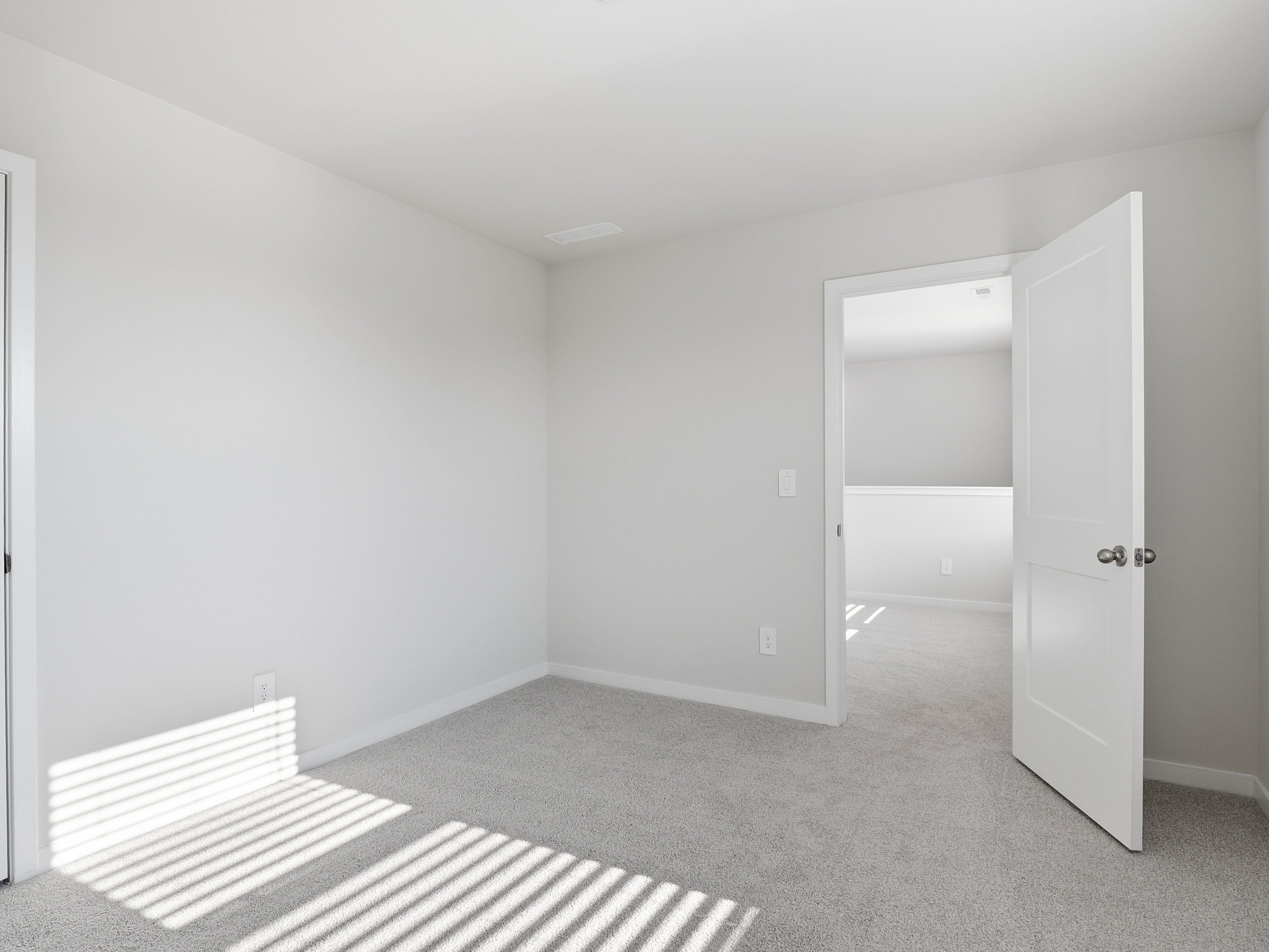Secondary bedroom in the Paisley floorplan at a Meritage Homes community in Clayton, NC.