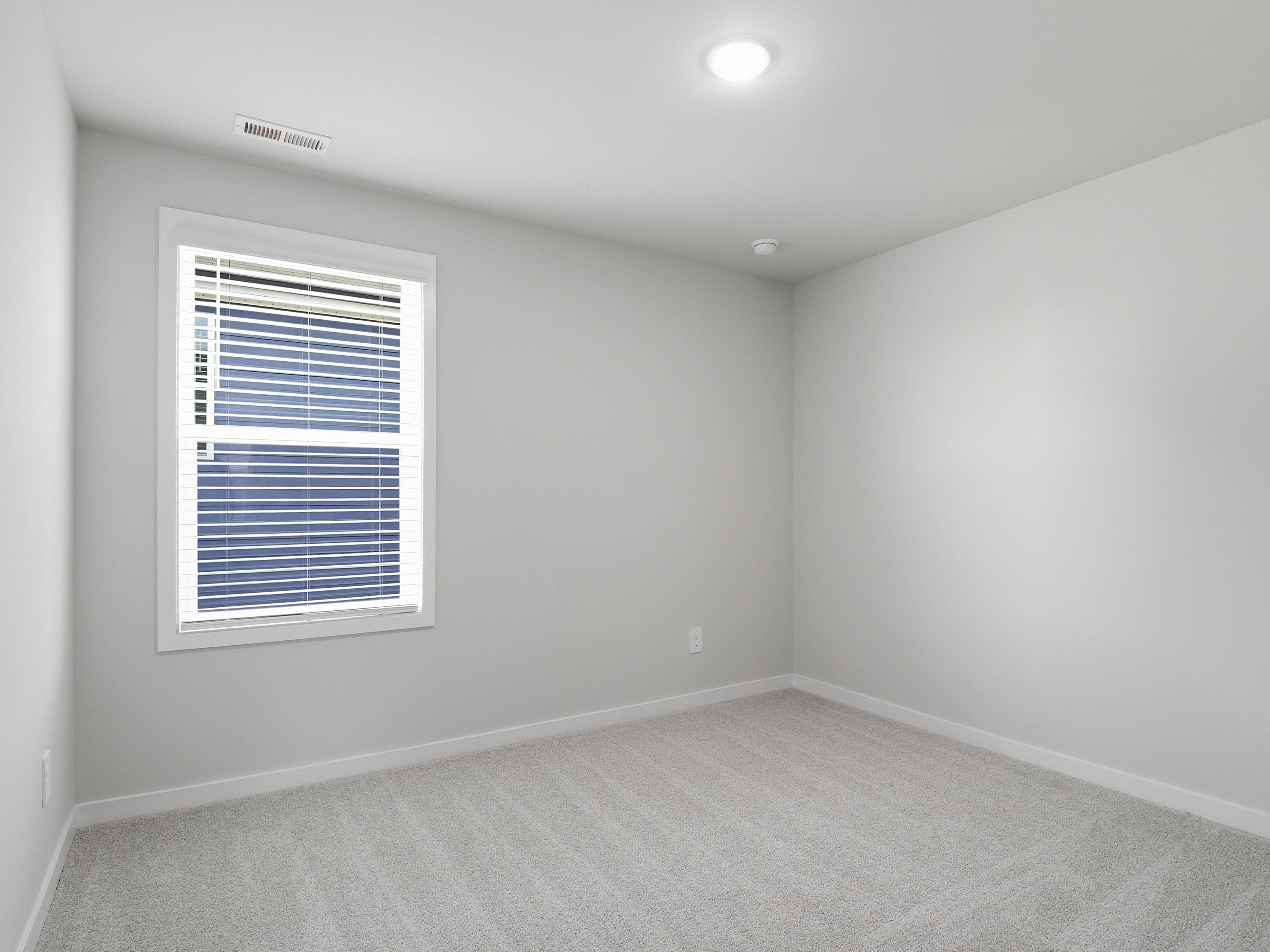 Secondary bedroom in the Paisley floorplan at a Meritage Homes community in Clayton, NC.
