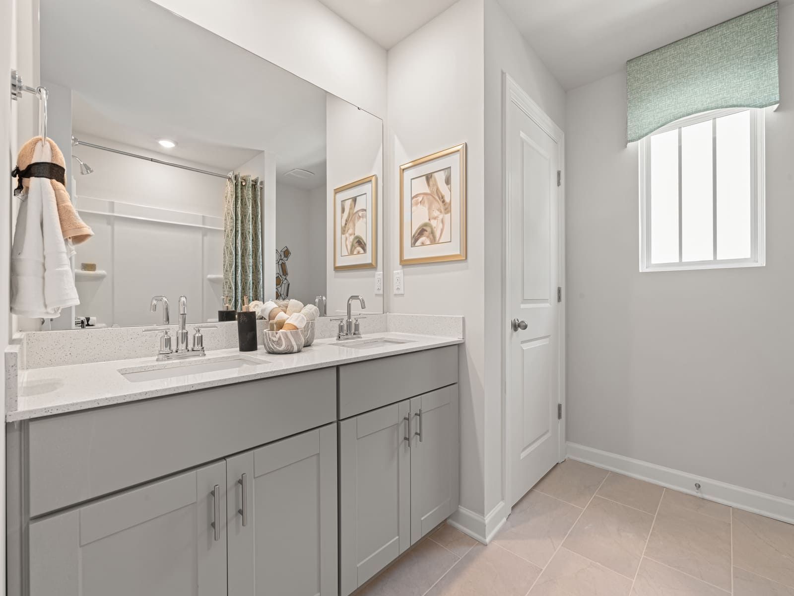 The secondary bathroom features an oversized tub and modern vanity.