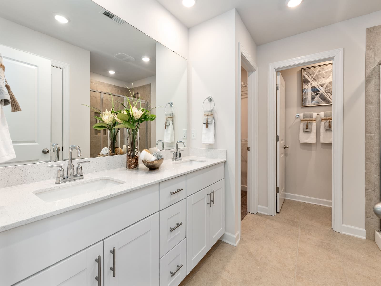The primary bathroom boasts a dual-sink vanity and walk-in shower.