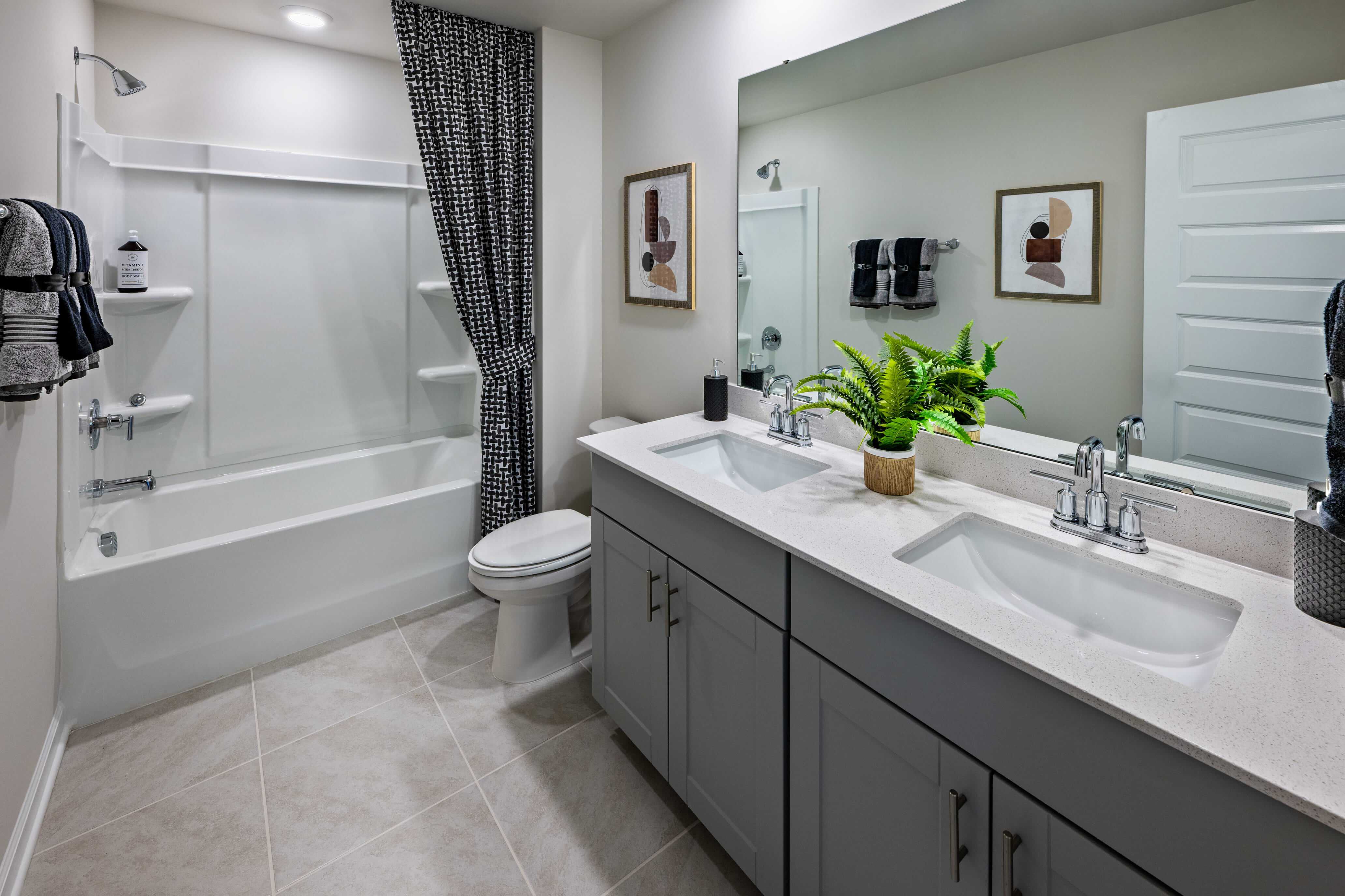 The secondary bath offers a space for guests to get ready. Photography from Holland Park.