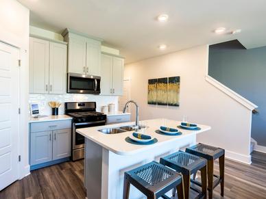 Enjoy your morning coffee at the stunning kitchen island. Photography from Townes at Garrison Grove.